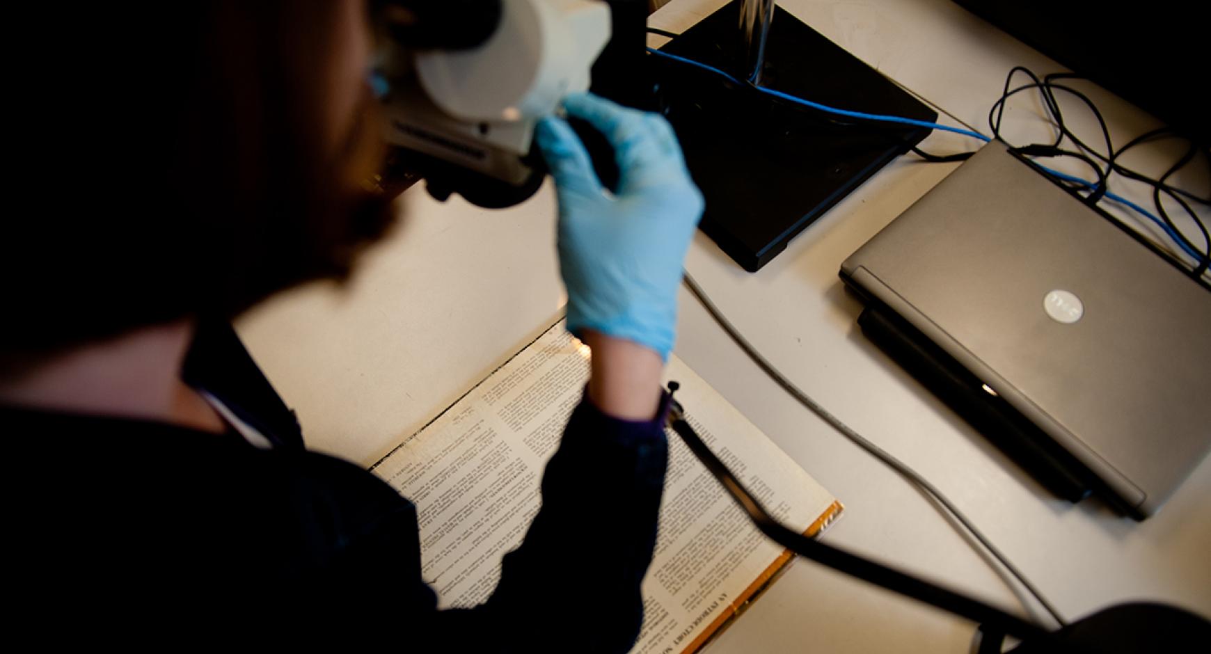 Preservation staff works on a volume