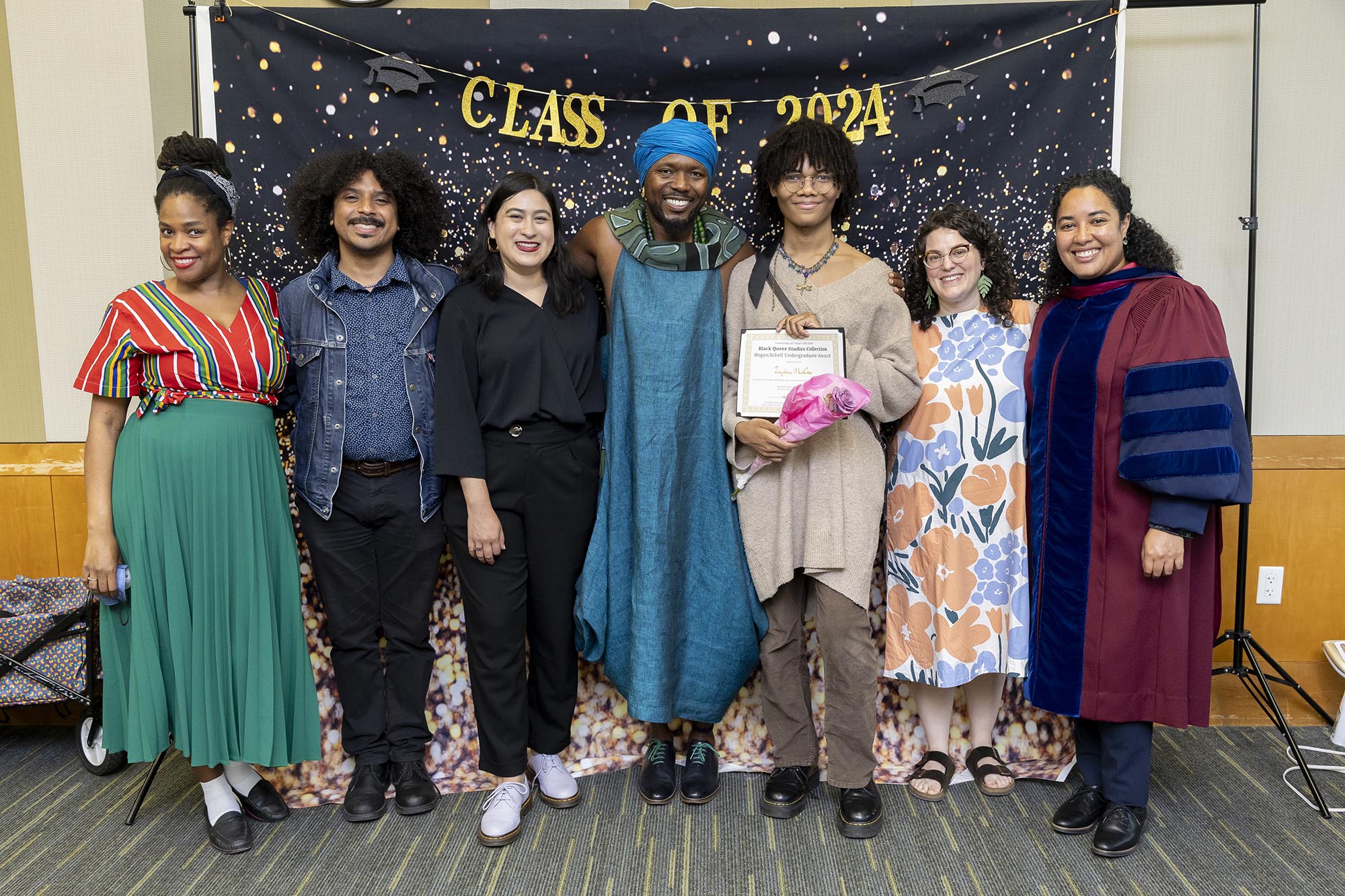 Image of award winners with Libraries' staff and faculty in front of "Class of 2024" banner.