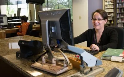 Librarian at FAL circulation desk